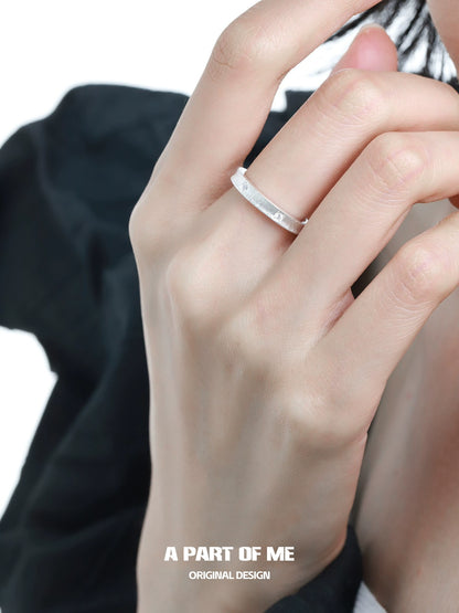 Minimalist silver ring showcased on a hand with delicate fingers, highlighting its elegant design