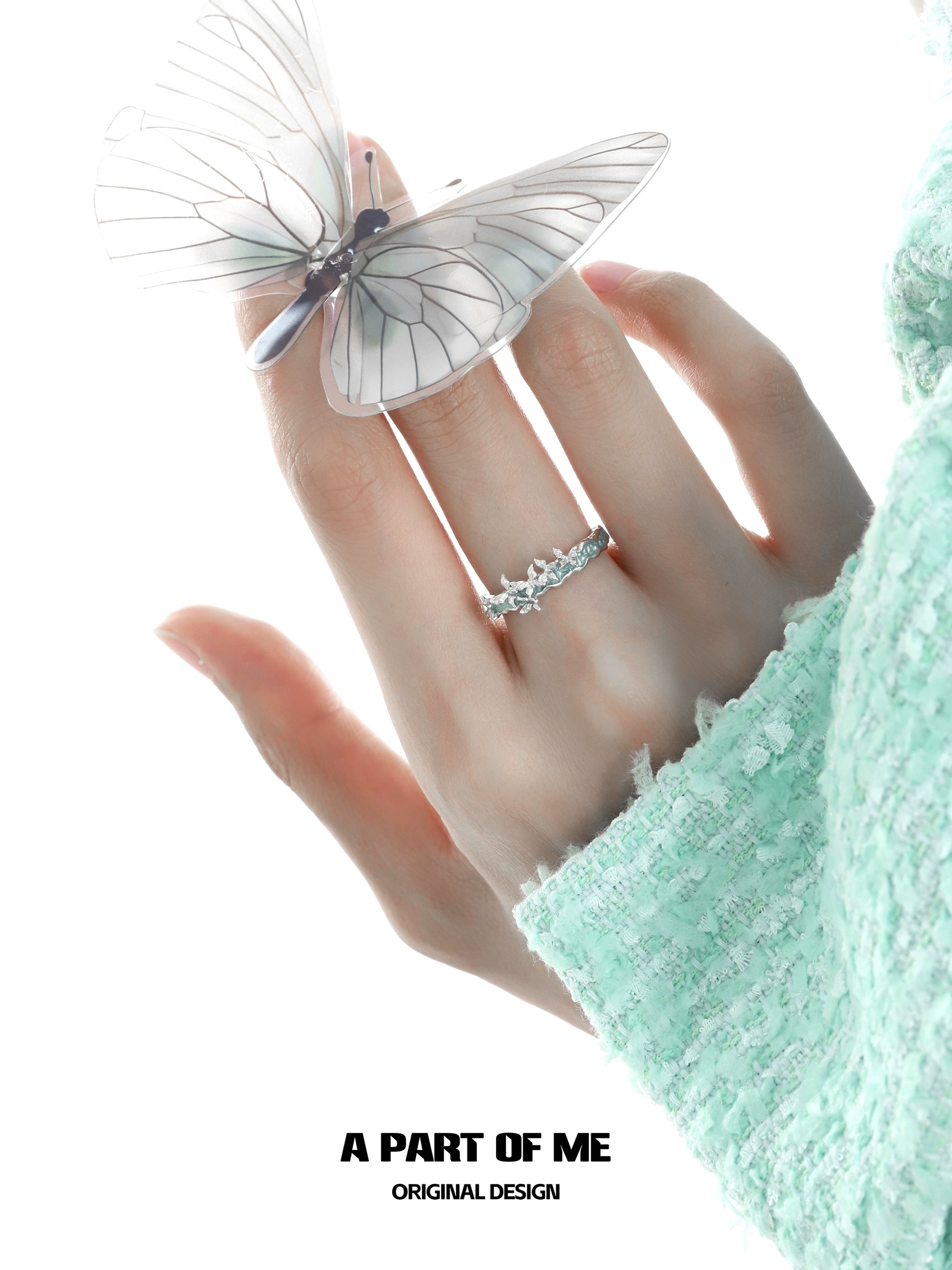 Elegant mint butterfly ring from A PART OF ME showcased on a hand with a delicate butterfly perched nearby