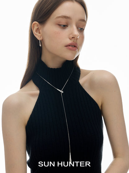 SUN HUNTER Molten Drop Necklace on a model wearing a black sleeveless top, showcasing elegant style