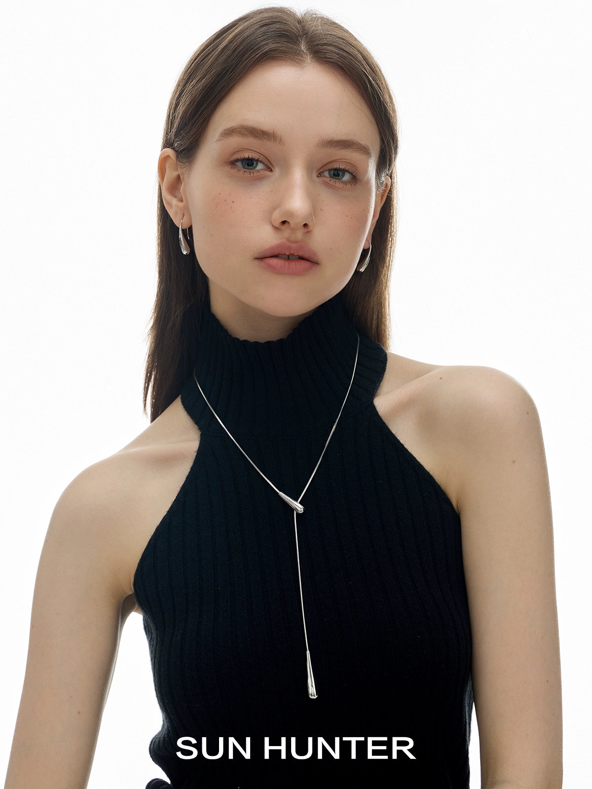 SUN HUNTER Molten Drop Necklace worn by a model in a black sleeveless top