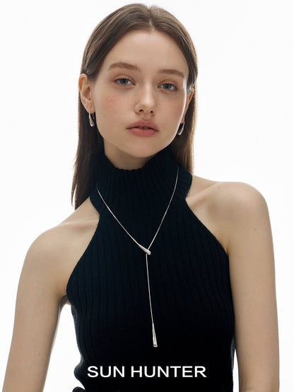 SUN HUNTER Molten Drop Necklace worn by a model in a black sleeveless top