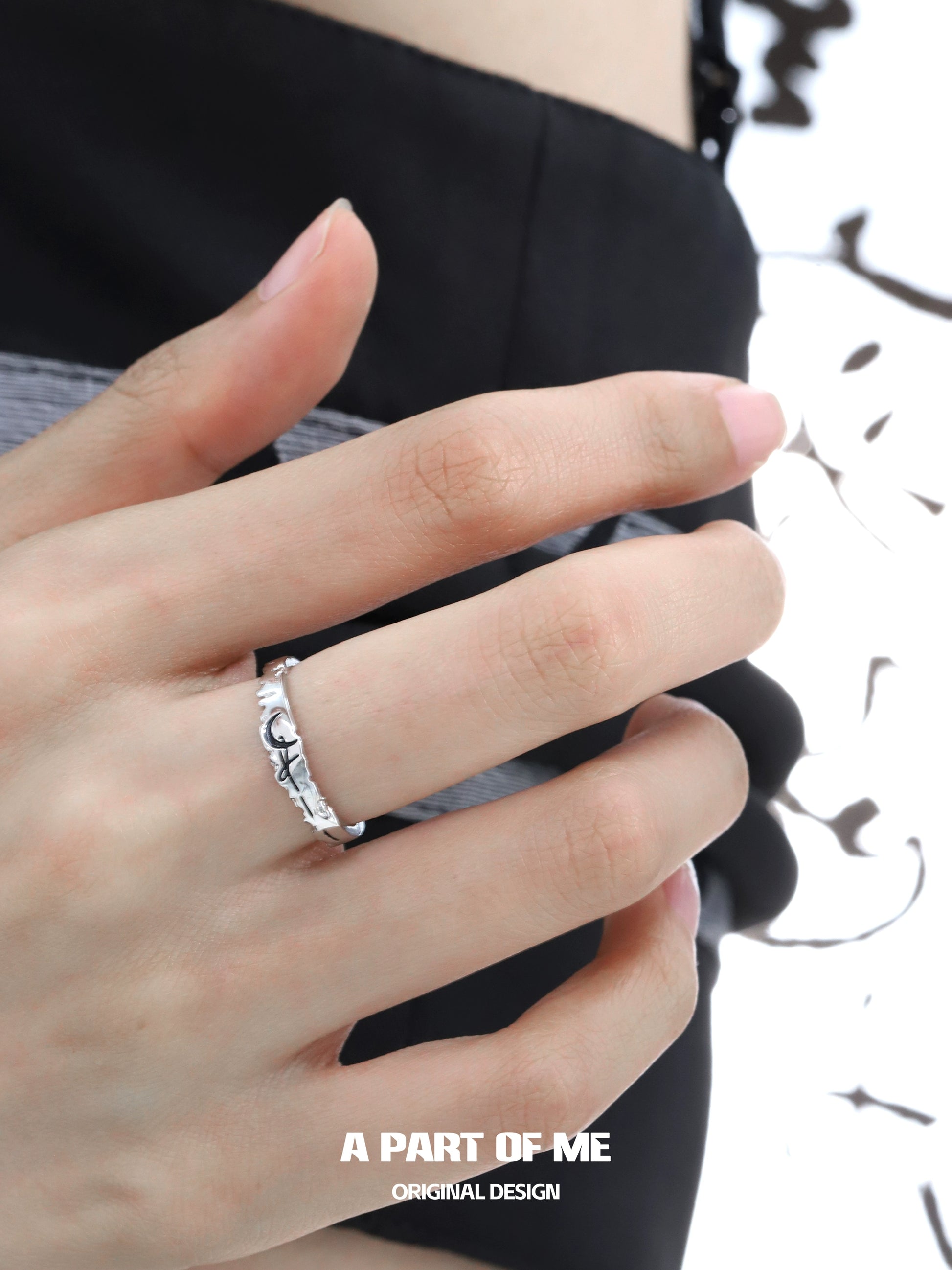 Moon rose couple rings in silver design worn on a hand, symbolizing love and connection