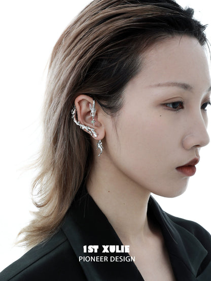 Stylish mystic dragon ear studs in silver, showcasing a unique design on a model's ear