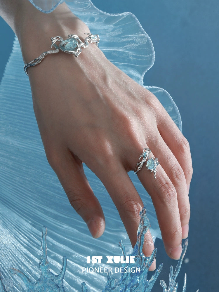 Elegant hand wearing an ocean dragon king sapphire bracelet paired with a matching ring
