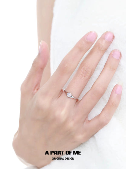 Elegant A PART OF ME opal color change ring displayed on a hand with a delicate design