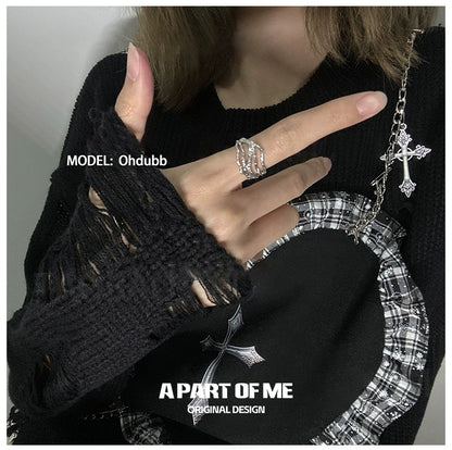 A PART OF ME bone minimalist ring shown on a hand wearing a black sweater with unique sleeve design