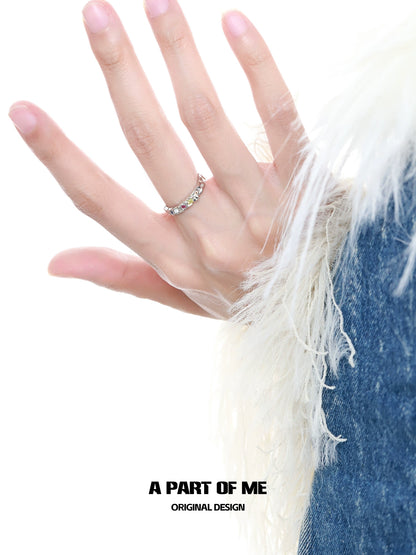 Colorful moonstone ring showcased on a hand with soft fur and blue denim background