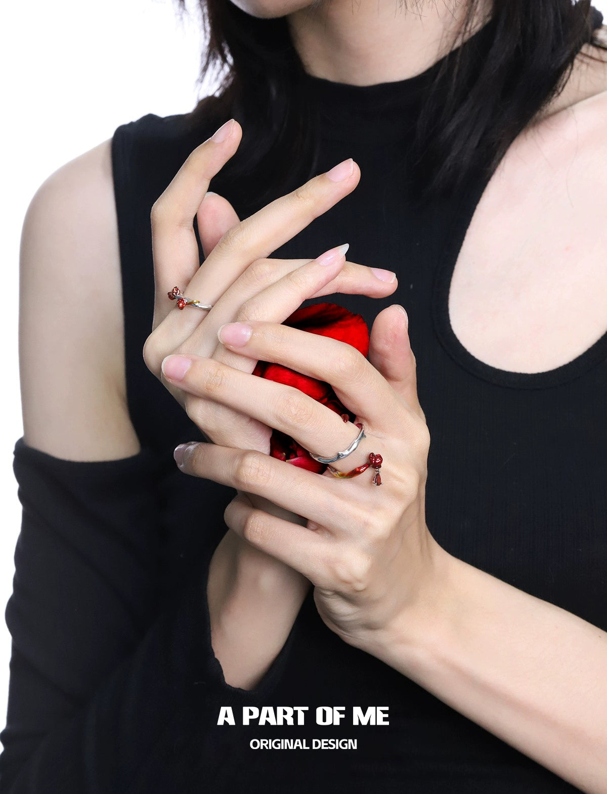 Heartburst rose silver ring showcased on elegantly styled hands holding a red gem