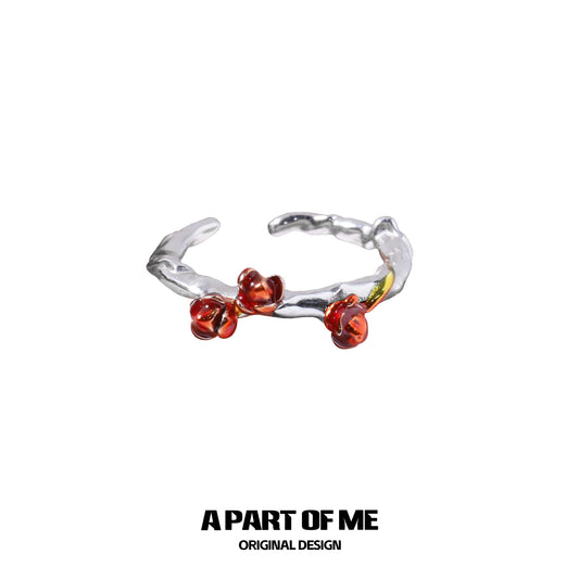 Heartburst rose silver ring with delicate red rose accents and a textured band for a unique design