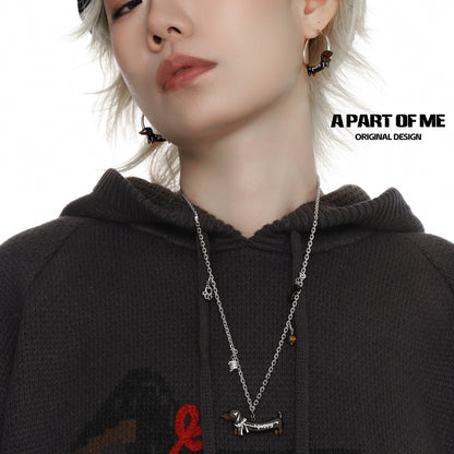 Stylish model wearing a lucky dachshund necklace with matching earrings from A PART OF ME