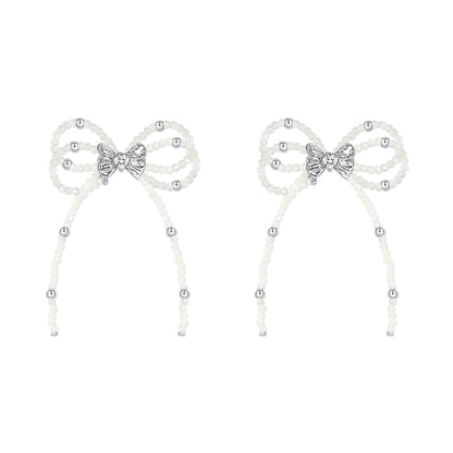 SUN HUNTER pearl bow ribbon earrings featuring elegant design with silver accents and delicate pearls
