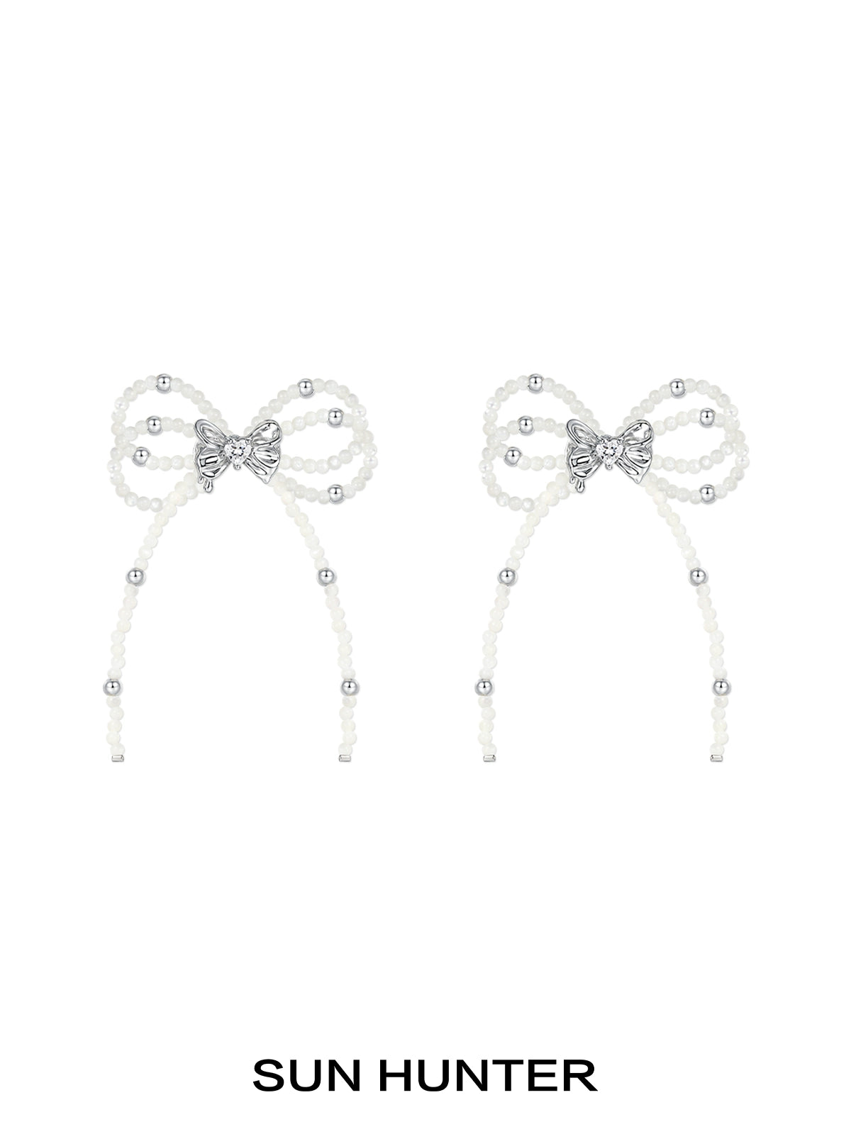 Elegant SUN HUNTER pearl bow ribbon earrings featuring sparkling accents for a stylish look