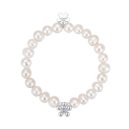 Elegant SUN HUNTER pearl bracelet for women featuring a silver flower charm and lustrous pearls