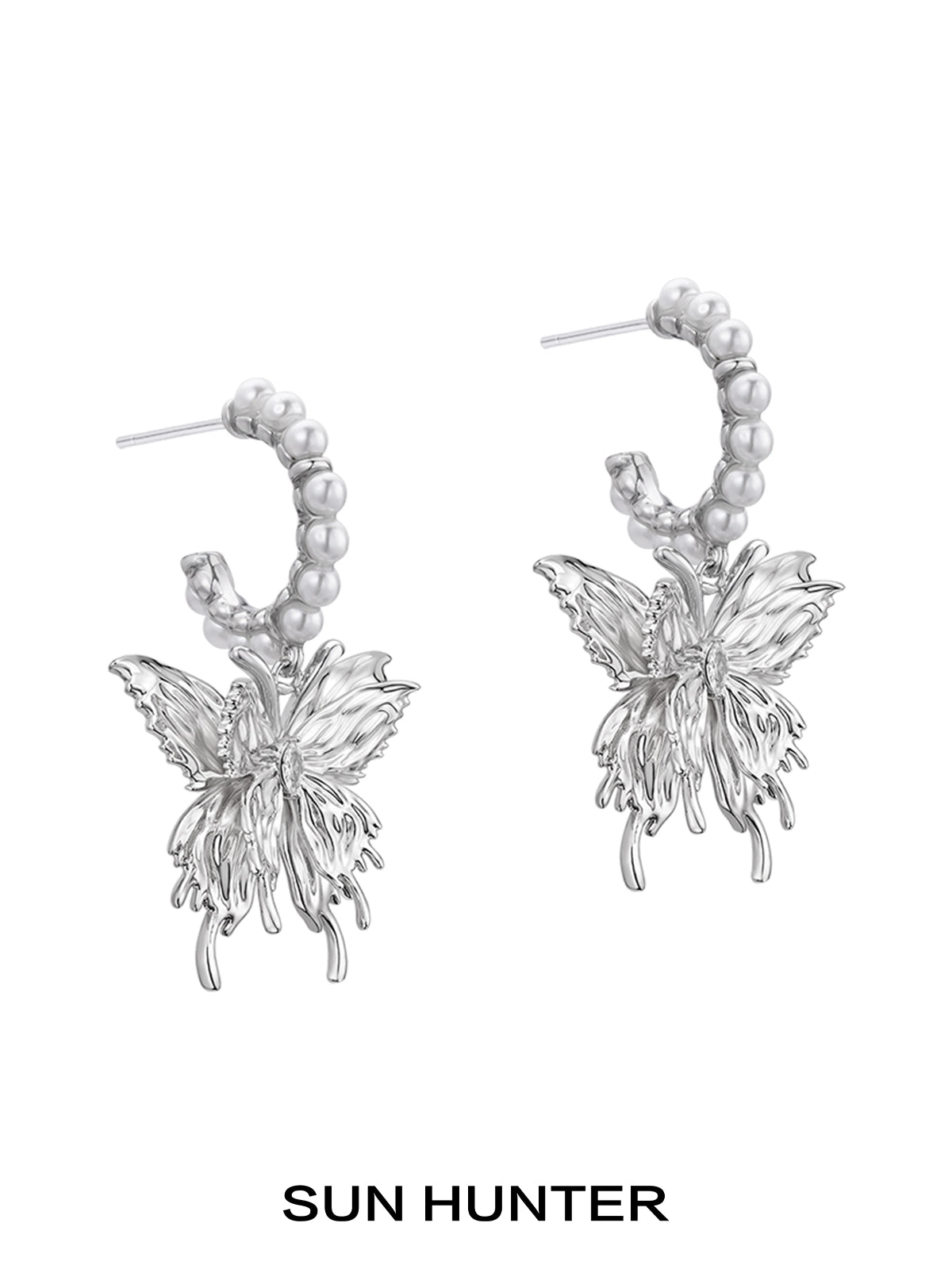 Elegant pearl butterfly earrings by SUN HUNTER featuring intricate metal design with pearl accents
