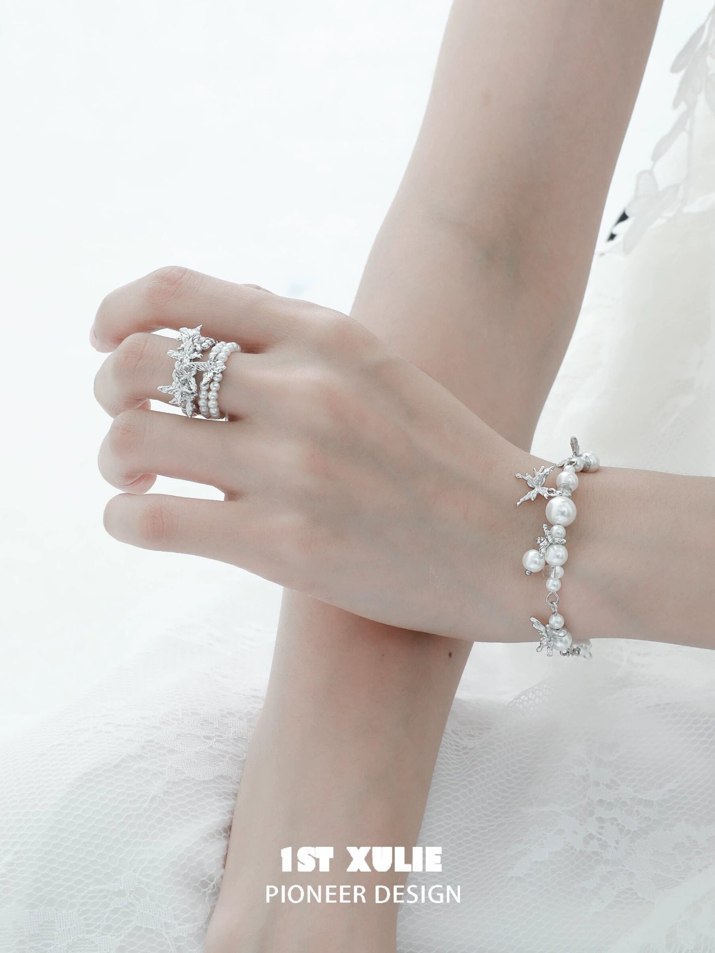 Elegant pearl butterfly ring alongside matching pearl bracelet, ideal for special occasions