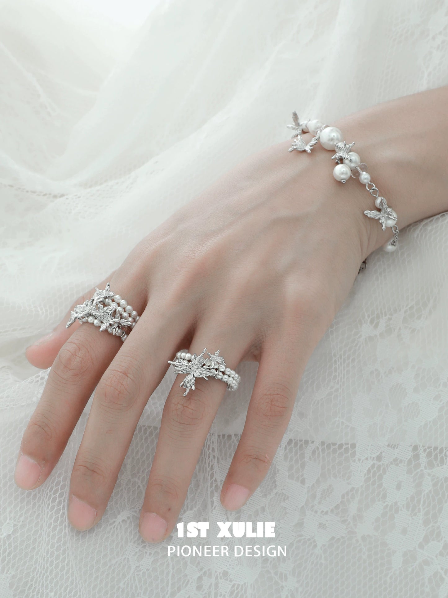 Elegant pearl butterfly ring showcased on a hand with matching pearl bracelet for a delicate look