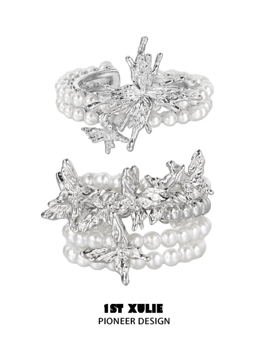 Elegant pearl butterfly ring with silver detailing and multiple pearl strands for a vintage look