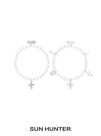 SUN HUNTER pearl cross bracelet featuring elegant pearls and a stylish cross charm