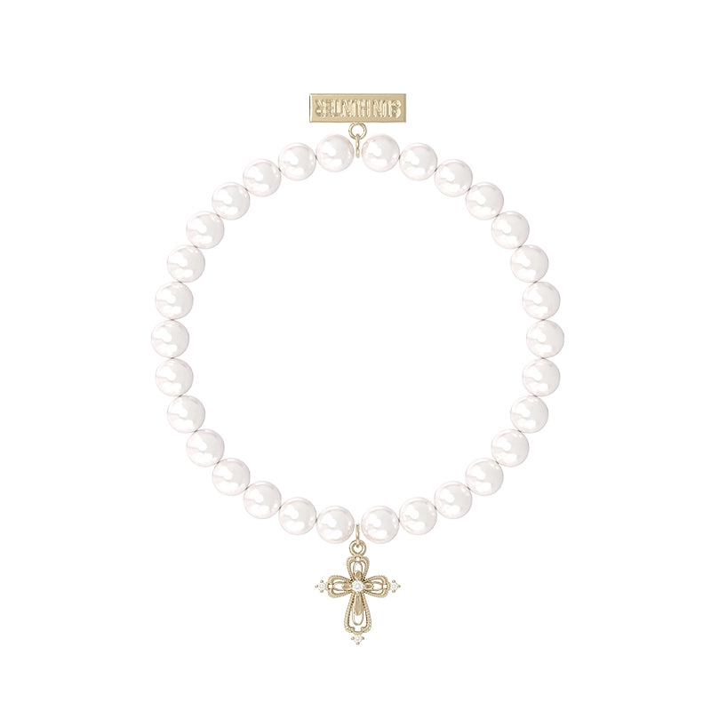 Elegant pearl cross bracelet featuring a delicate cross charm and shiny white pearls