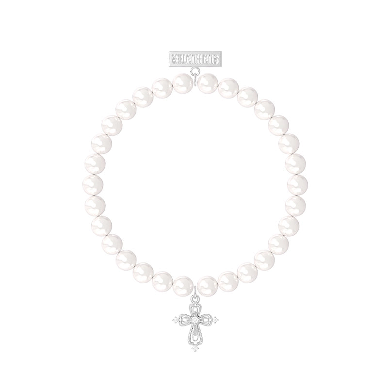Elegant pearl cross bracelet featuring white pearls and a silver cross charm for stylish expression