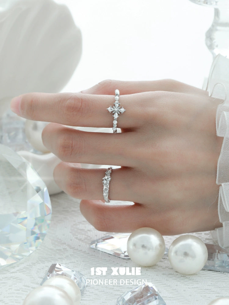 Beautiful pearl cross silver ring displayed on a hand with sparkling crystals and pearls