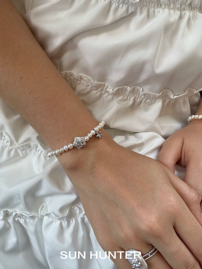 Elegant SUN HUNTER pearl star bracelet featuring a delicate star charm and pearls