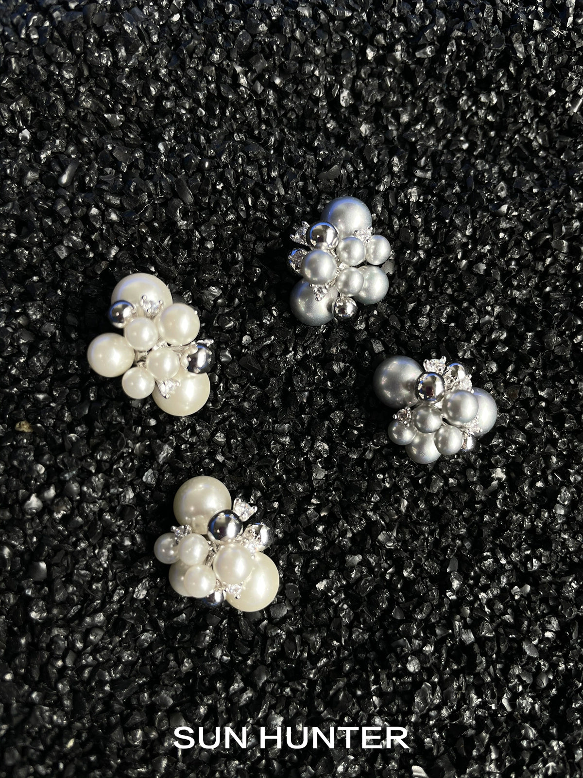 Elegant SUN HUNTER pearl zircon statement earrings featuring clusters of white and silver pearls