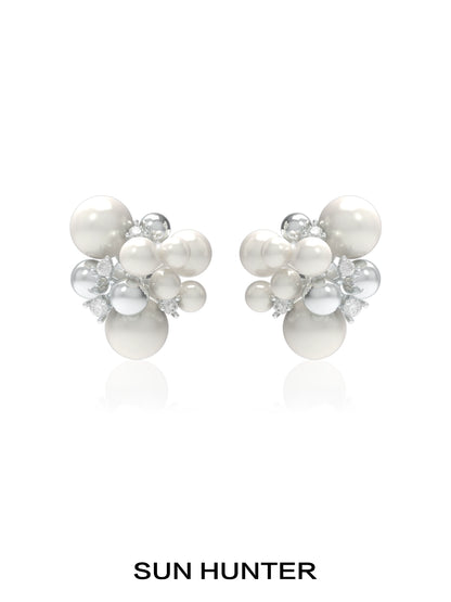 SUN HUNTER pearl zircon statement earrings featuring a cluster design with lustrous pearls and sparkling zircon.