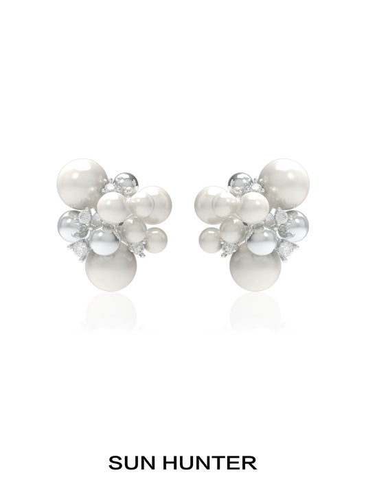 SUN HUNTER pearl zircon statement earrings featuring a cluster design with lustrous pearls and sparkling zircon.