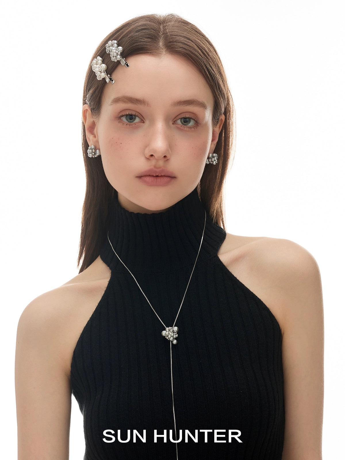 Model wearing pearl zircon statement earrings paired with stylish accessories from SUN HUNTER