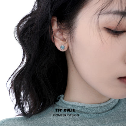 Aqua gemstone stud earrings showcased on a model, adding a touch of elegance to any outfit