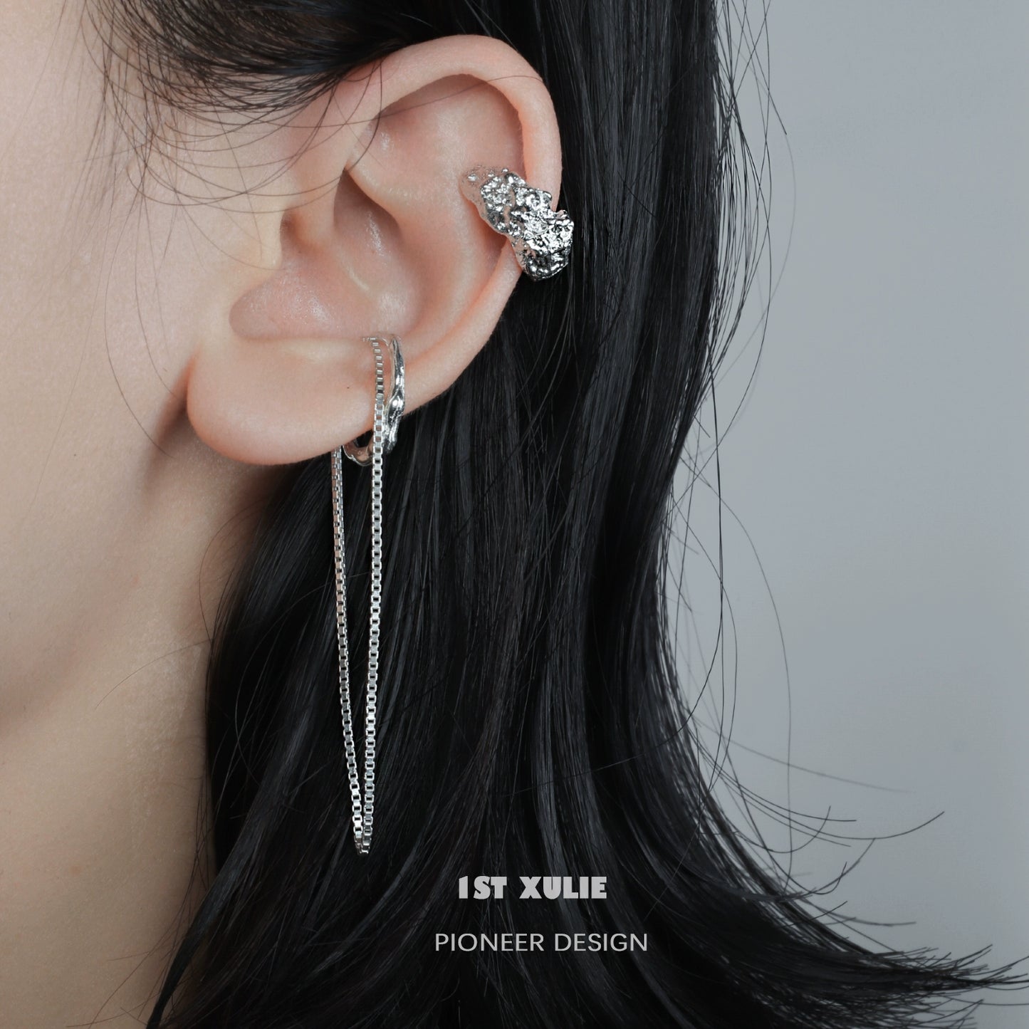 Frosted ear cuff by 1ST XULIE featuring a unique design with chain detailing for a stylish look