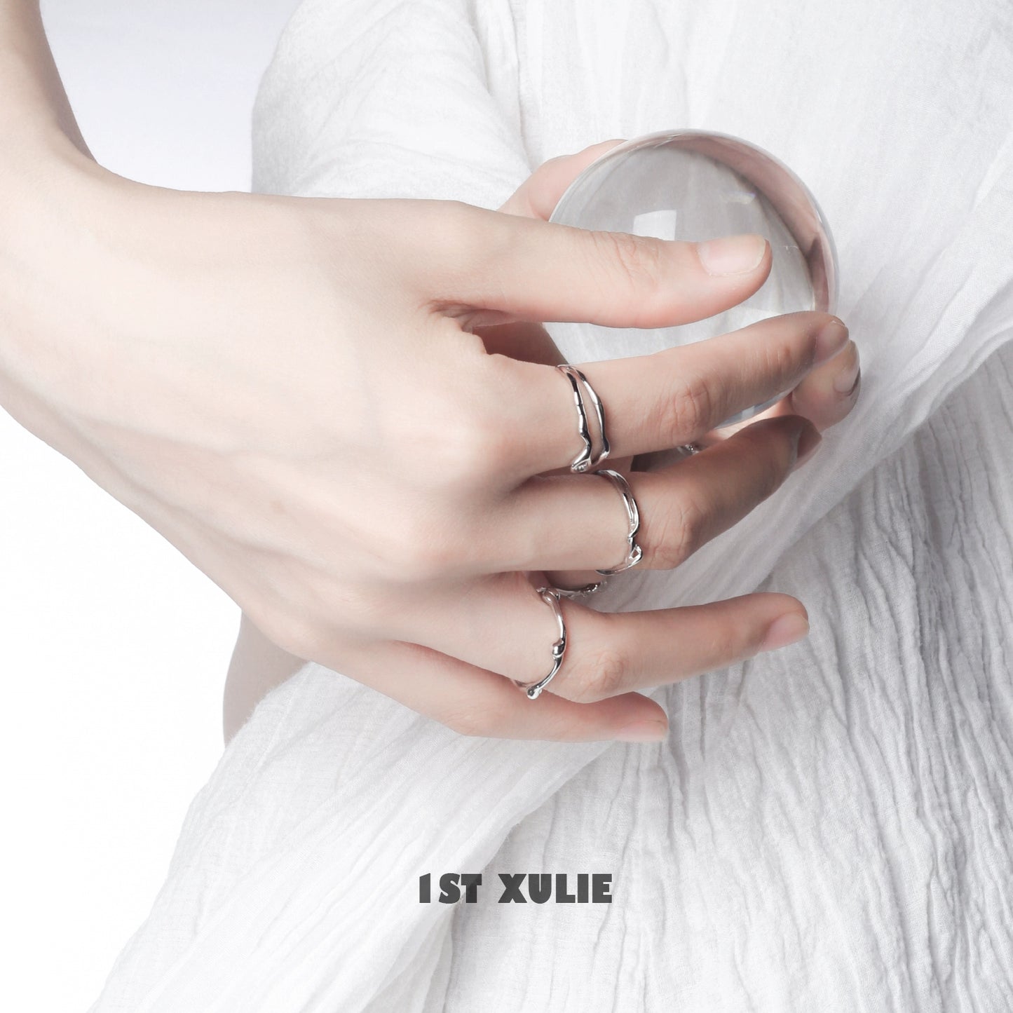 Close-up of a hand wearing a minimalist silver line art ring, showcasing its elegant design