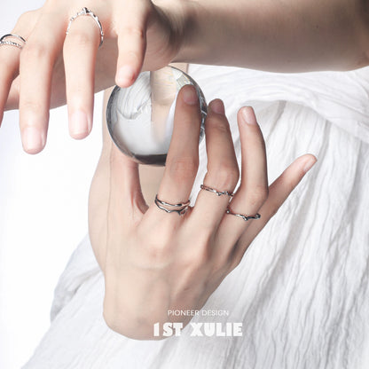 Elegant minimalist silver line art ring displayed on hand holding a crystal ball