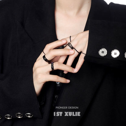 Stylish Y2K silver ring worn on fingers with a chic black jacket for modern fashion enthusiasts