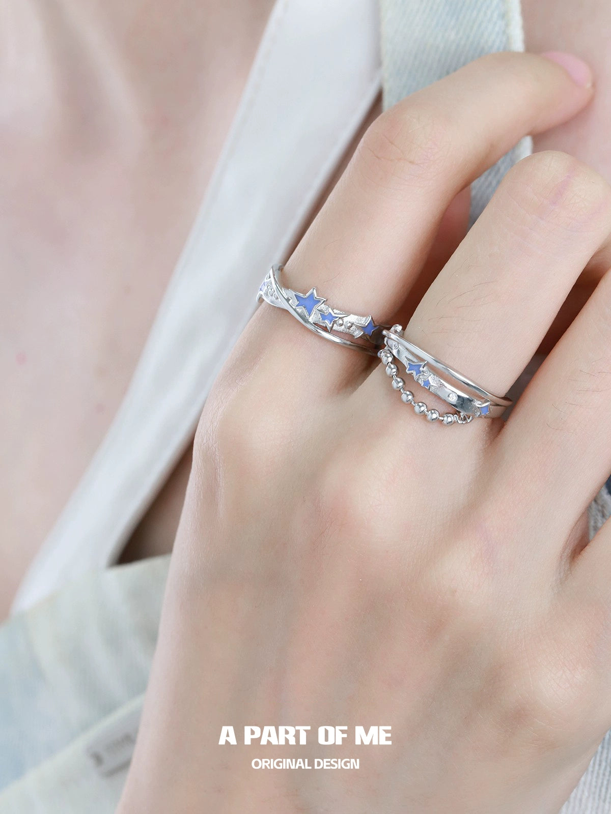 A PART OF ME planet chain ring showcased on a model's hand with stylish stars and elegant design