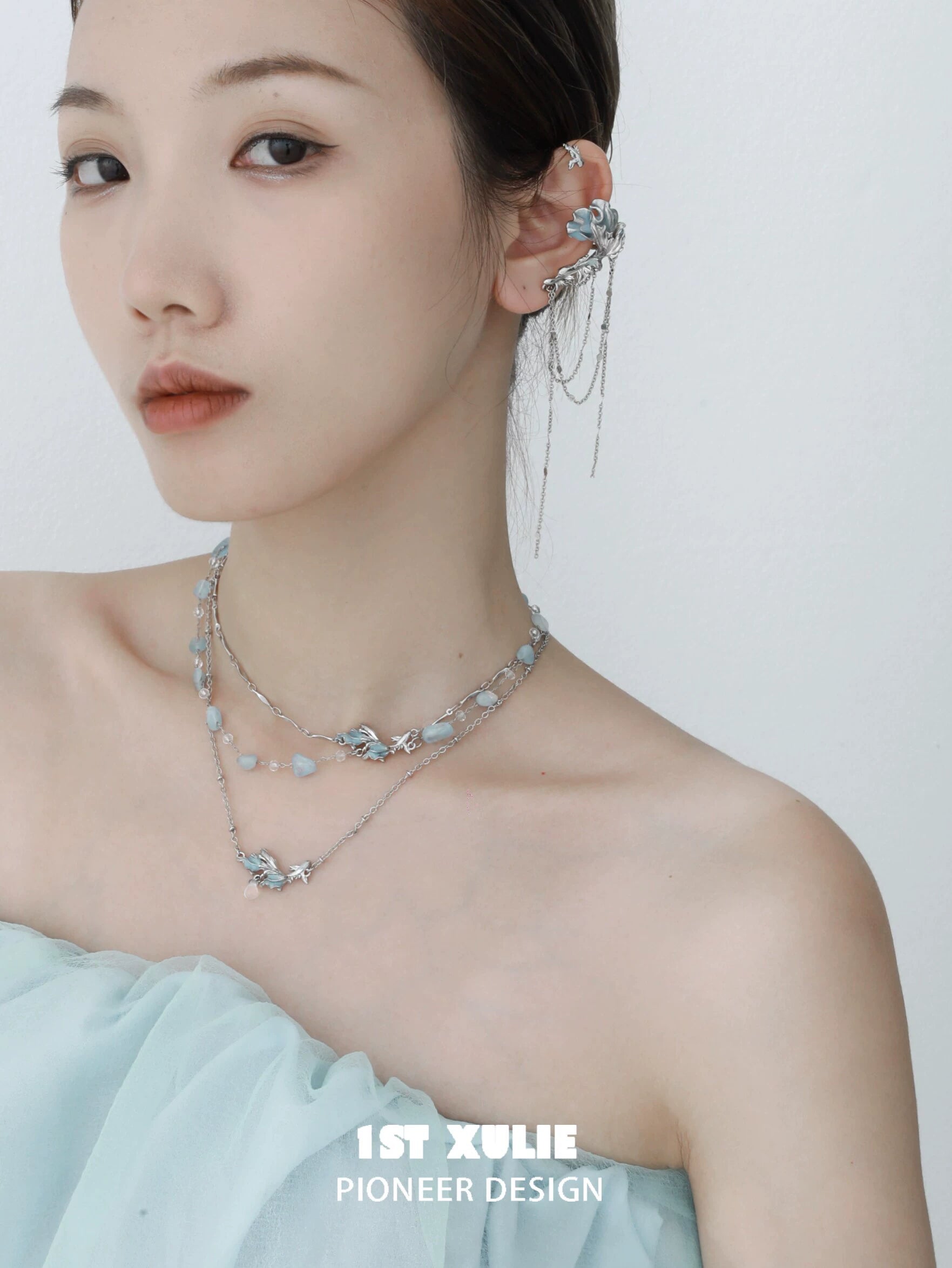 Model wearing a playful fish necklace adorned with beads and silver accents for a trendy look