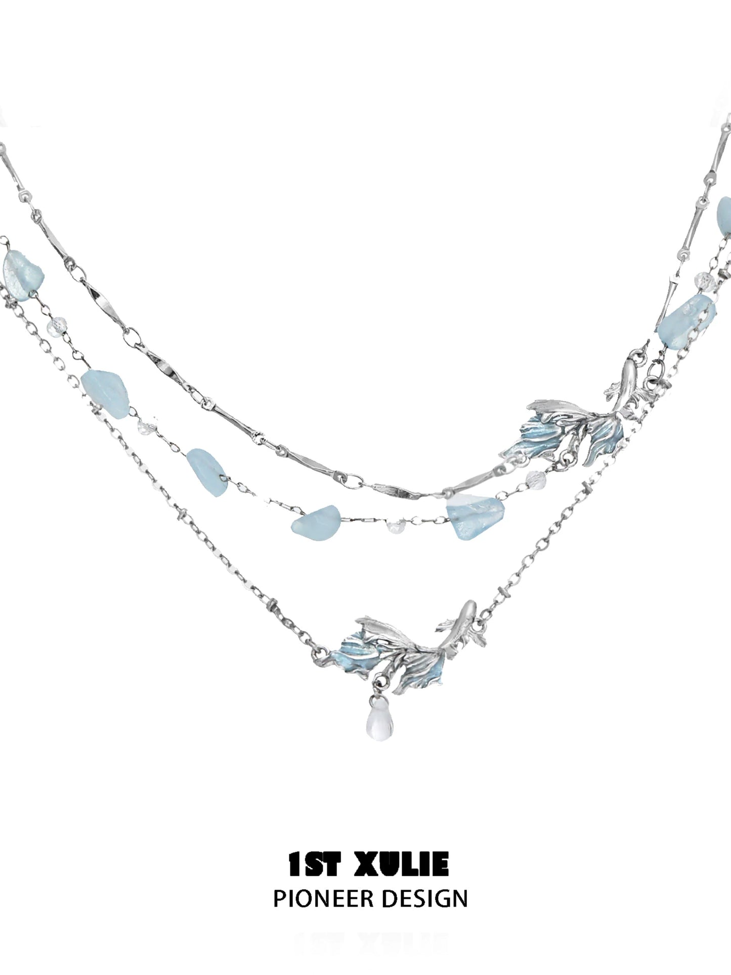 Elegant playful fish necklace with layered silver chains and blue gemstones for a whimsical touch