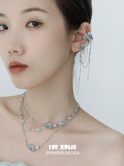 Playful fish necklace by 1ST XULIE featuring silver chains and elegant ocean-themed charms