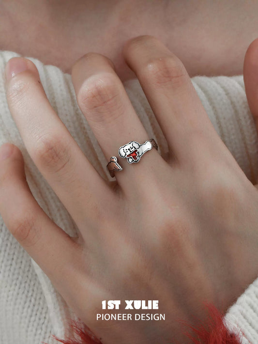 Playful puppy silver ring by 1STXULIE showcased on a hand with a cozy sweater