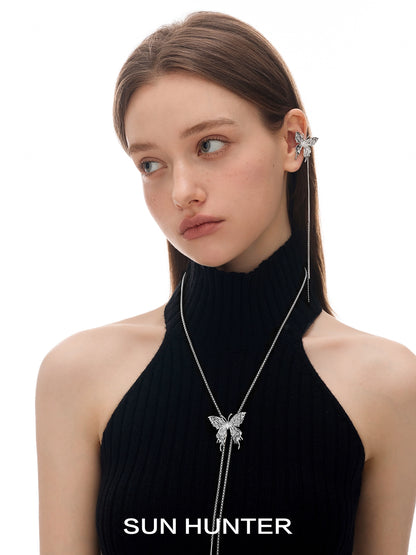 Model wearing SUN HUNTER punk butterfly ear cuffs with a stylish black top and sleek hairstyle