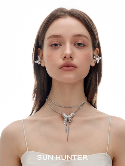 Model wearing SUN HUNTER punk butterfly ear cuffs with matching butterfly necklace for a stylish look