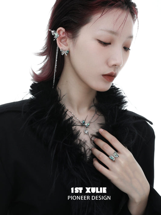 Punk butterfly earrings displayed on a model with a stylish outfit and layered accessories