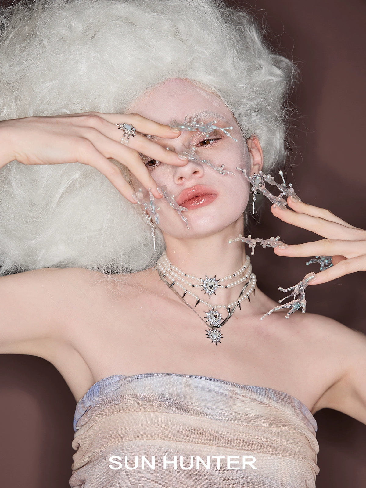 Model showcasing SUN HUNTER punk heart rivet ring with an artistic hair and makeup design