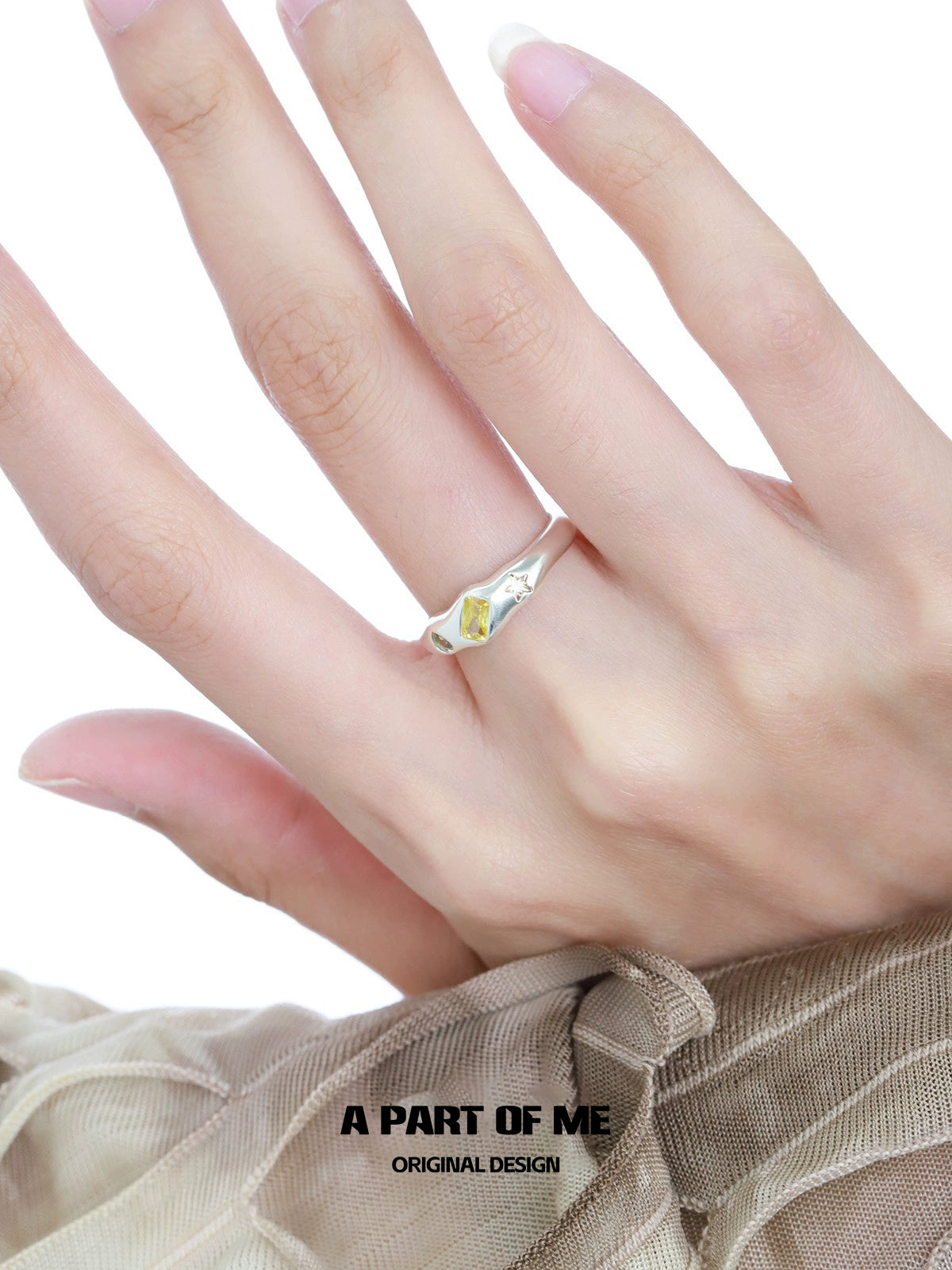 Elegant A PART OF ME rainbow star zircon ring displayed on a hand with delicate fingers