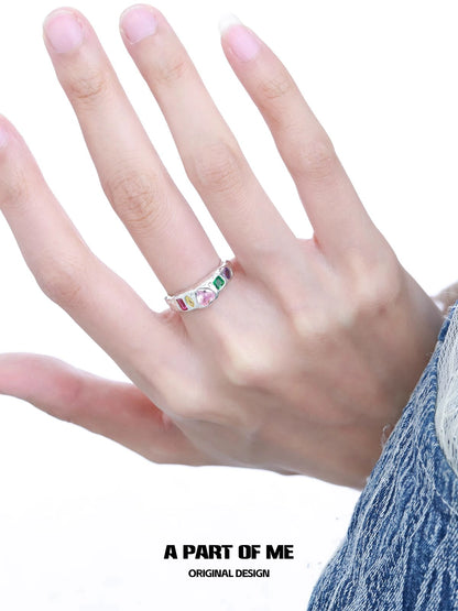 Delicate A PART OF ME rainbow zircon love ring displayed on a hand with colorful gemstones