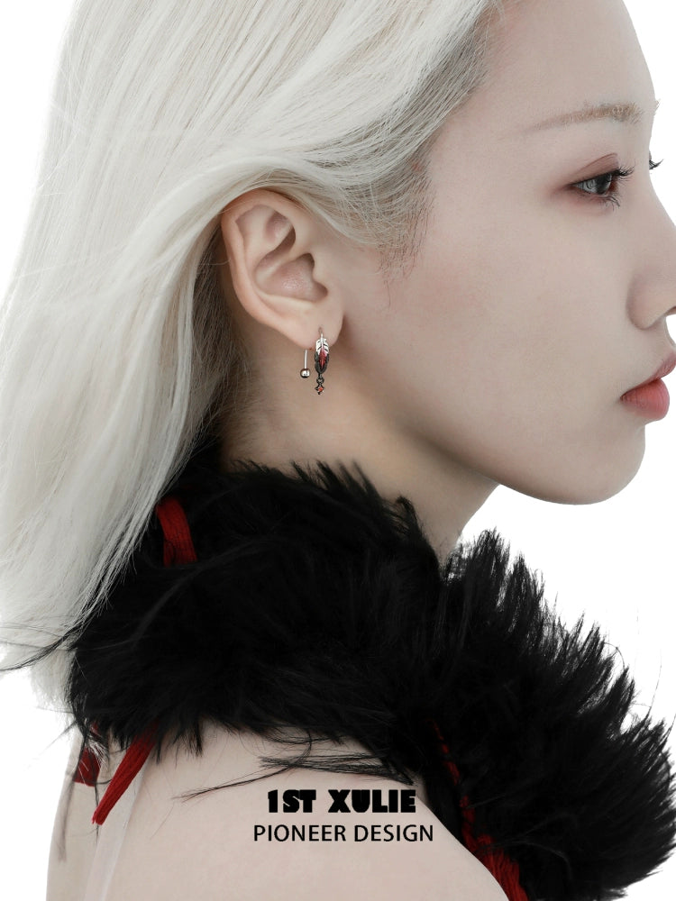 Elegant red feather earrings designed by 1ST XULIE, showcasing a unique and stylish look