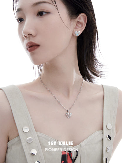 Model wearing a shimmering removable clavicle chain necklace with a heart pendant for elegant styling