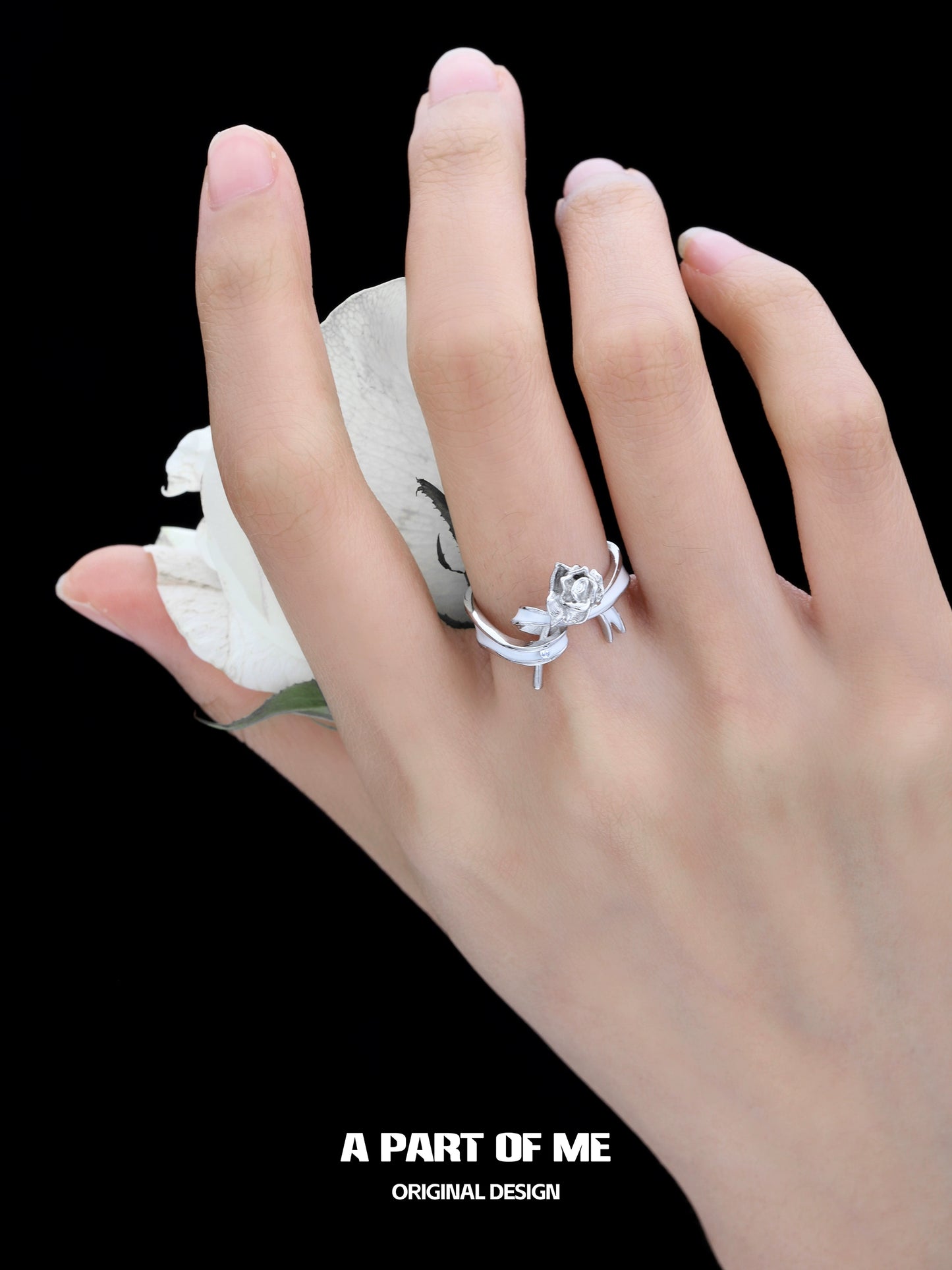 Elegant rose bow silver ring displayed on a hand holding a white rose, showcasing its unique design