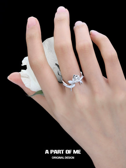 Elegant rose bow silver ring displayed on a hand holding a white rose, showcasing its unique design